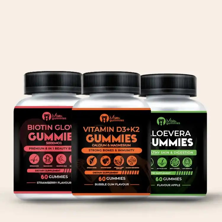 Three bottles of Mister Gummies dietary supplements for adults: Biotin Glow Gummie (5000mcg, Strawberry flavour, for 8-in-1 beauty benefits), Vitamin D3 + K2 Gummies with Calcium & Magnesium (Bubble Gum flavour, for strong bones & immunity), and Aloe Vera Gummies (Flavour Apple, for healthy skin & digestion). Each bottle contains 60 gummies.