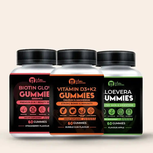 Three bottles of Mister Gummies dietary supplements for adults: Biotin Glow Gummie (5000mcg, Strawberry flavour, for 8-in-1 beauty benefits), Vitamin D3 + K2 Gummies with Calcium & Magnesium (Bubble Gum flavour, for strong bones & immunity), and Aloe Vera Gummies (Flavour Apple, for healthy skin & digestion). Each bottle contains 60 gummies.